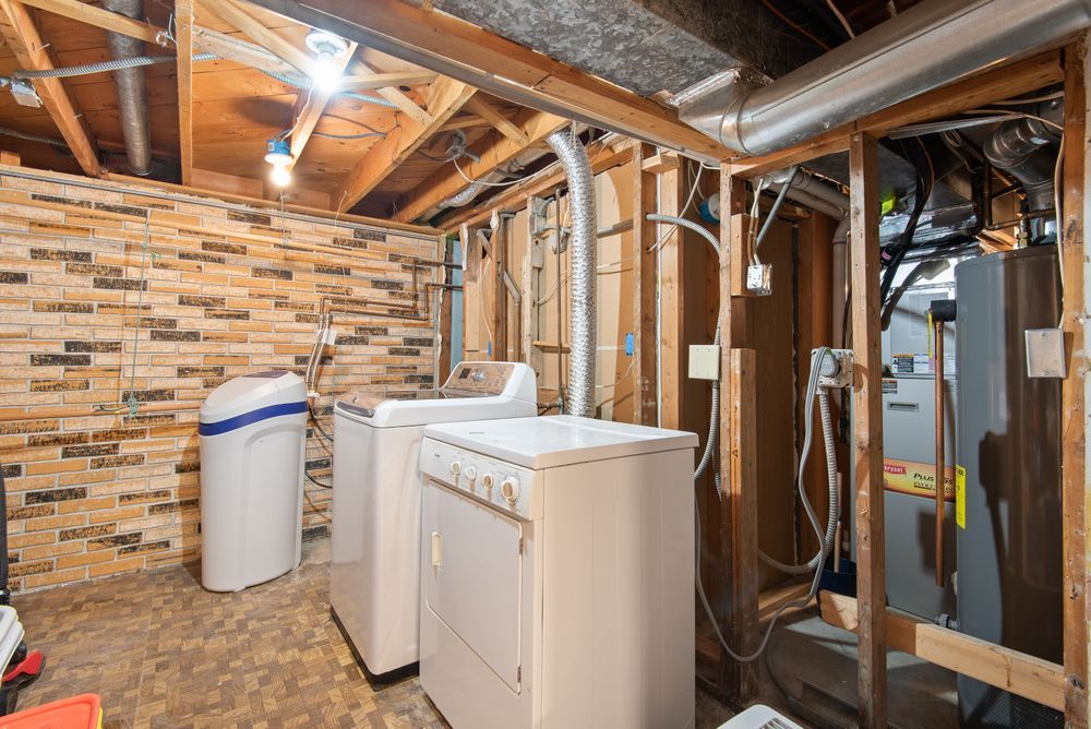 Basement laundry and utility room with a water heater and furnace, the space that floods first in many Seattle homes