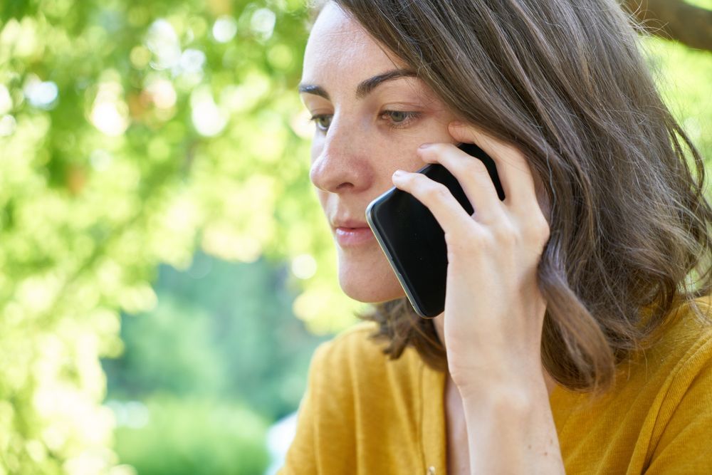 A homeowner on the phone asking for help after finding water damage at home