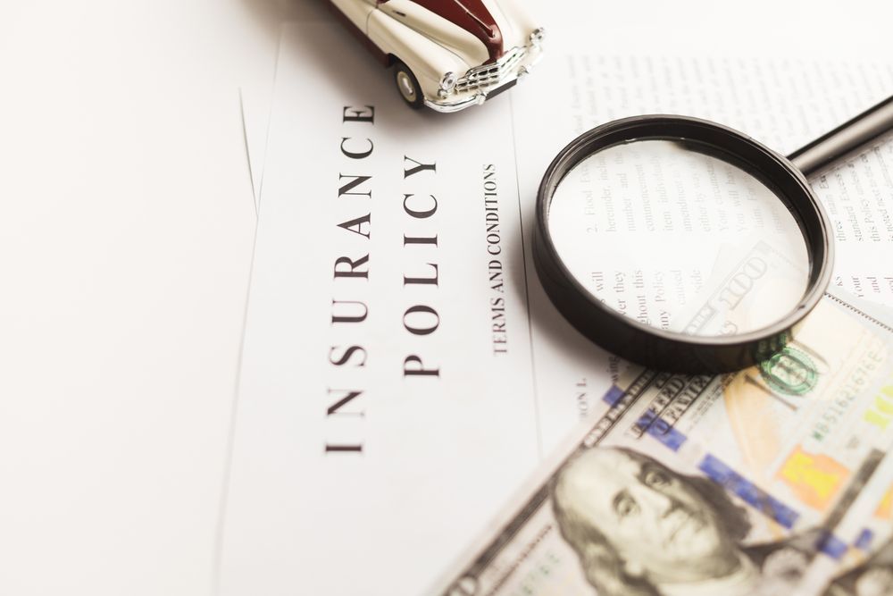 A home insurance policy document with a magnifying glass during a water damage claim