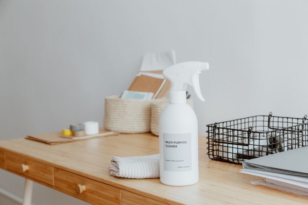 Cleaning sprays and supplies laid out for sanitizing a home after water damage