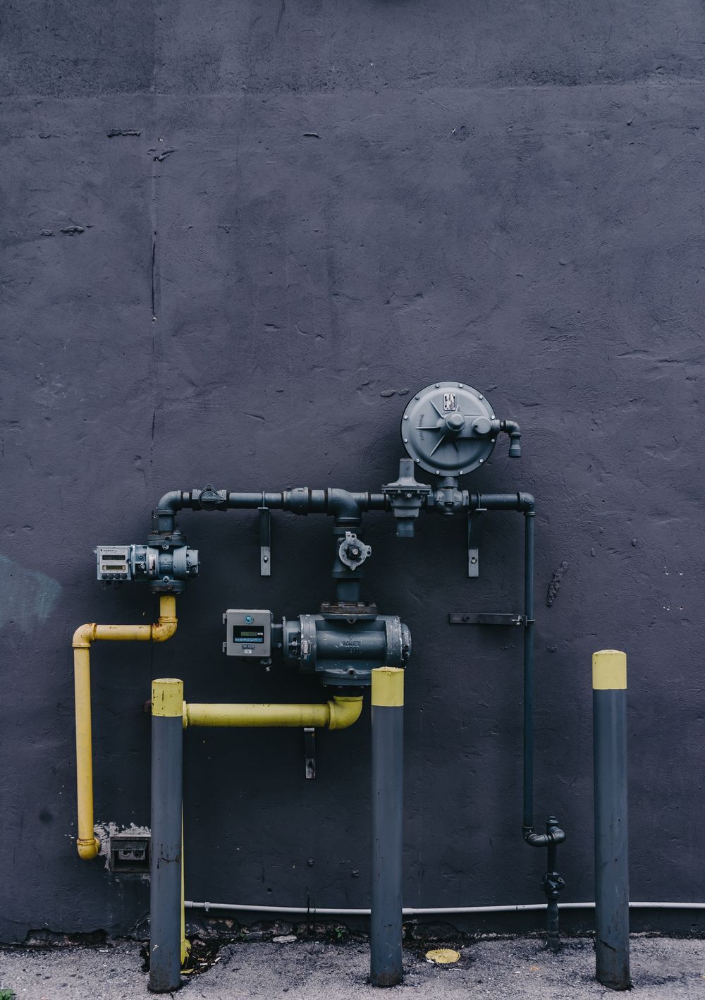Exposed plumbing pipes and valves in a home utility area