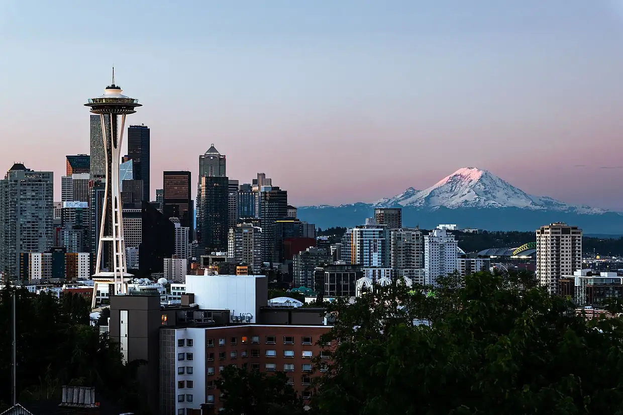 Seattle skyline with the Space Needle and Mount Rainier at dusk